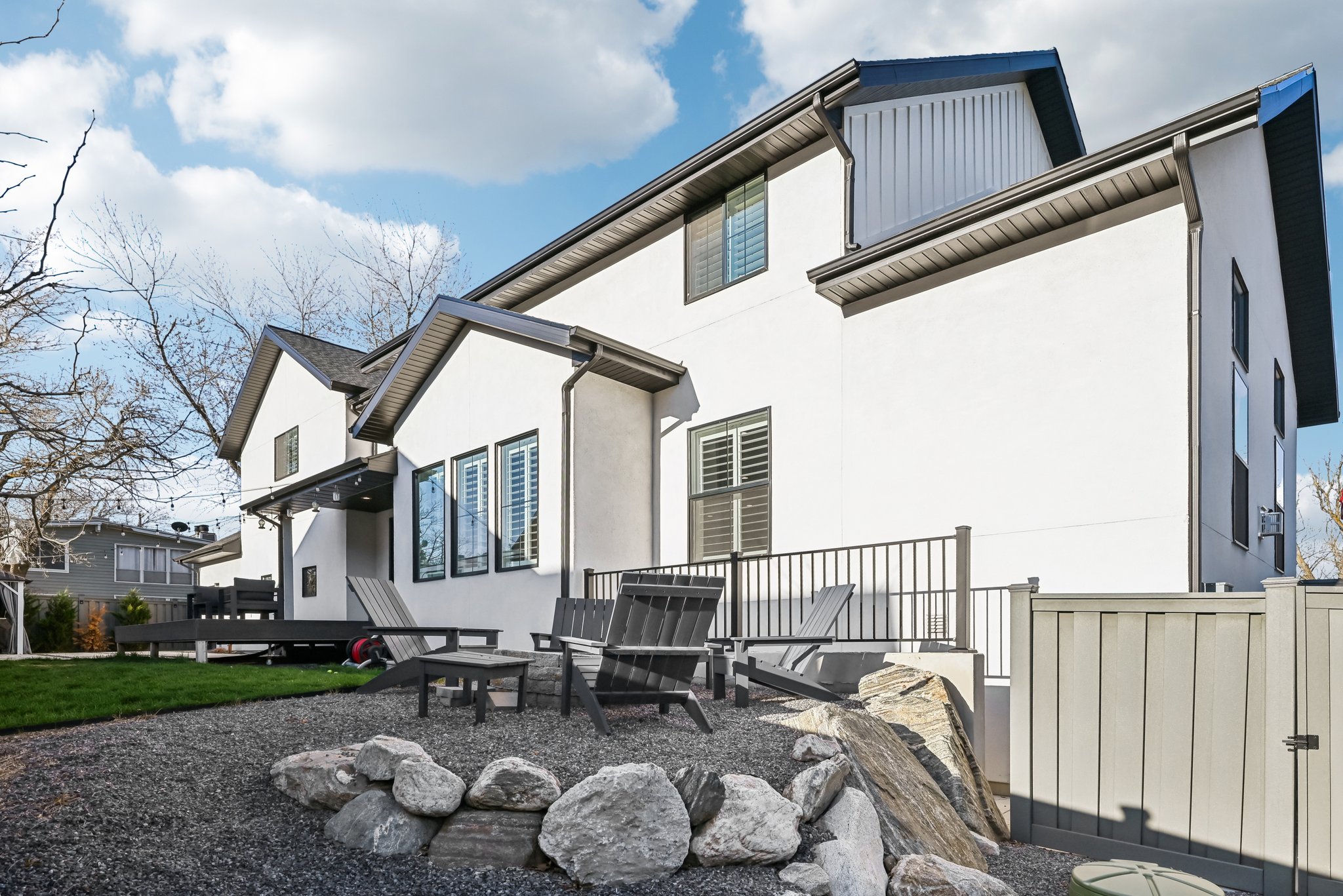 Back of property with fence, a patio, and stucco siding