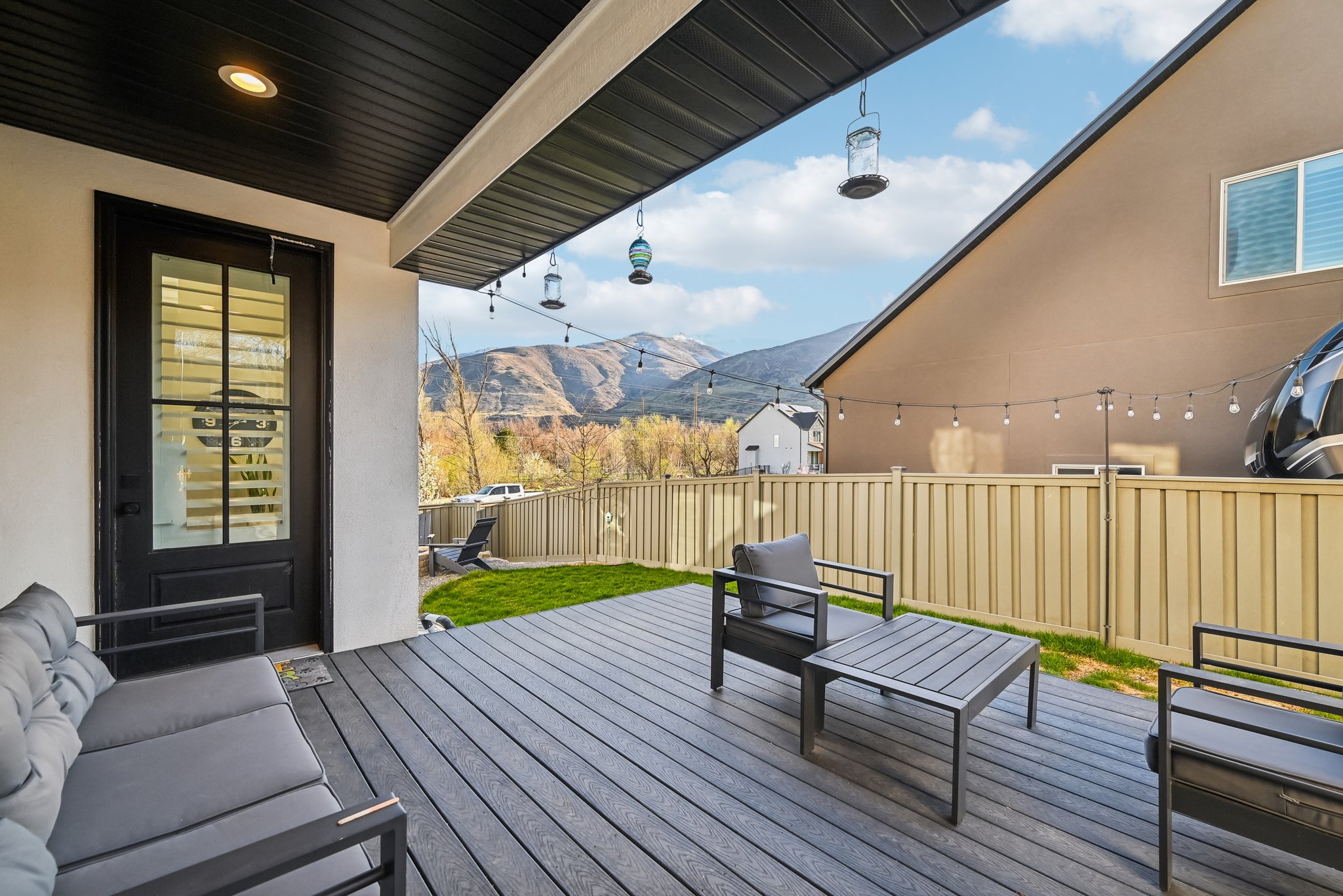 Deck with an outdoor living space, a mountain view, and fence