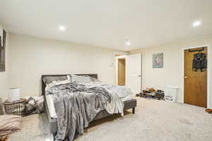 Carpeted bedroom with recessed lighting