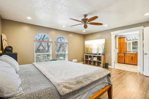 Bedroom with recessed lighting, light wood finished floors, and a textured ceiling