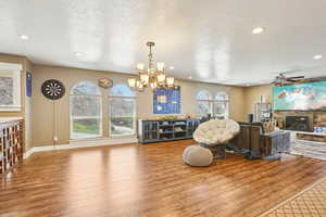 Living area featuring recessed lighting, a textured ceiling, wood finished floors, and a fireplace
