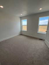 Carpeted Bedroom featuring tall baseboards and recessed lighting