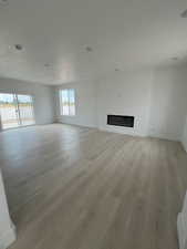 Great Room with fireplace and light wood-style floors