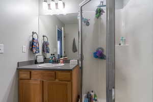 Full bathroom with a stall shower and vanity
