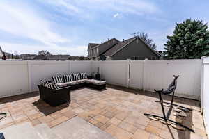 View of patio with a fenced backyard and an outdoor hangout area
