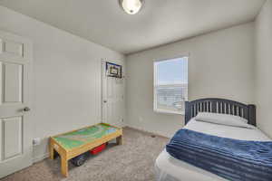 Bedroom with baseboards, a textured ceiling, and carpet