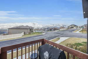 Balcony featuring a mountain view, area for grilling, and a residential view