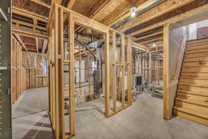 Unfinished basement featuring washer / dryer and stairs