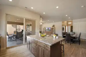 Kitchen featuring a kitchen breakfast bar, vaulted ceiling, recessed lighting, light wood-type flooring, and a chandelier