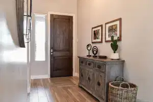 Foyer featuring baseboards, light wood-style floors, and plenty of natural light