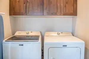 Laundry room featuring washing machine and dryer and cabinet space