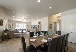 Dining area with wood tiled floor, ceiling fan with notable chandelier, a textured ceiling, and recessed lighting