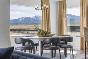 Dining space featuring wood finished floors, a mountain view, and a chandelier