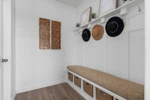Mudroom with dark wood-style floors and baseboards
