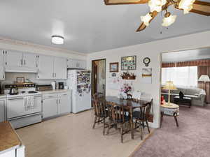 Dining area featuring ceiling fan and light wood-style flooring