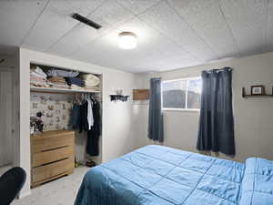 Bedroom featuring visible vents, a closet, and carpet flooring