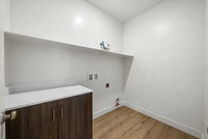 Laundry room with baseboards, washer hookup, laundry area, light wood finished floors, and hookup for an electric dryer