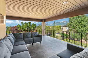 View of patio / terrace with a balcony, an outdoor hangout area, and a mountain view
