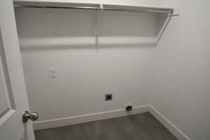 Clothes washing area with baseboards, laundry area, and electric dryer hookup