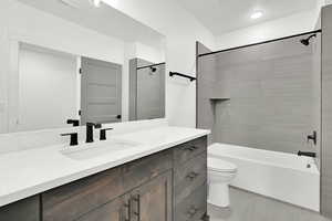 Full bath featuring shower / tub combination, tile patterned flooring, vanity, toilet, and visible vents