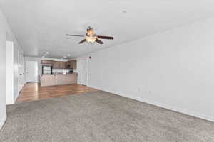 Unfurnished living room featuring recessed lighting, ceiling fan,  and carpet floors