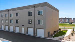 View of building exterior featuring an attached garage