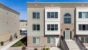View of front of house with brick siding and stucco siding