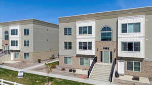 View of front of home with stucco siding and brick siding