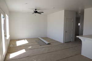 Empty room featuring ceiling fan