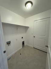 Laundry room featuring hookup for an electric dryer, baseboards, tile patterned floors, laundry area, and washer hookup