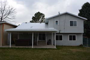 Rear view of home (East) and covered patio area.