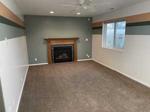 Family room with gas fireplace and ceiling fan.