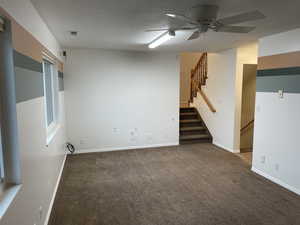 Family room with gas fireplace and ceiling fan.