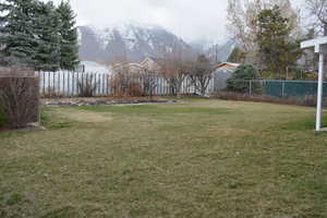 Fenced yard/mountain views.