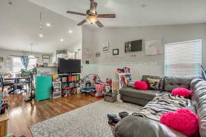 Living area featuring recessed lighting, vaulted ceiling, ceiling fan, and wood finished floors