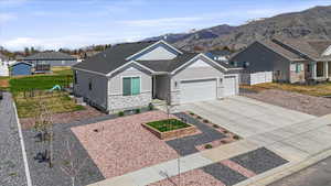 Ranch-style home with a front yard, an attached garage, fence, a residential view, and driveway