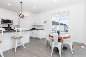 Kitchen featuring white cabinetry, visible vents, dark countertops, and appliances with stainless steel finishes