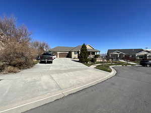 View of front facade with driveway and a garage