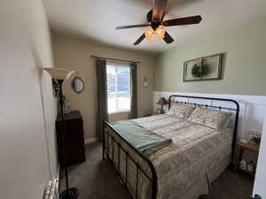 Bedroom featuring baseboards, carpet flooring, and ceiling fan
