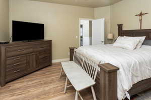 Master Bedroom with baseboards and light wood-type flooring