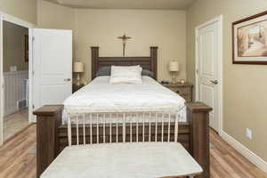 Master Bedroom with baseboards, visible vents, and wood finished floors
