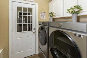 Laundry area featuring washer and dryer and cabinet space