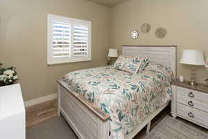 Bedroom featuring baseboards and wood finished floors