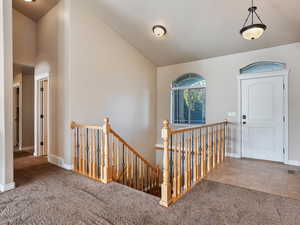 Entryway featuring baseboards, visible vents, and carpet
