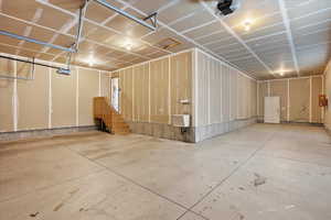 Garage featuring a garage door opener and a sink