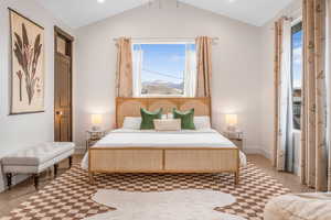 Bedroom featuring baseboards and lofted ceiling