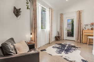 Interior space featuring light speckled floor, plenty of natural light, and lofted ceiling