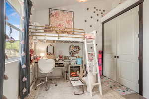 Bedroom with a closet and vaulted ceiling