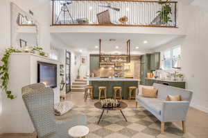 Living room featuring baseboards, visible vents, a high ceiling, and recessed lighting
