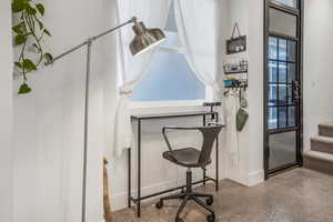 Office space featuring baseboards and speckled floor